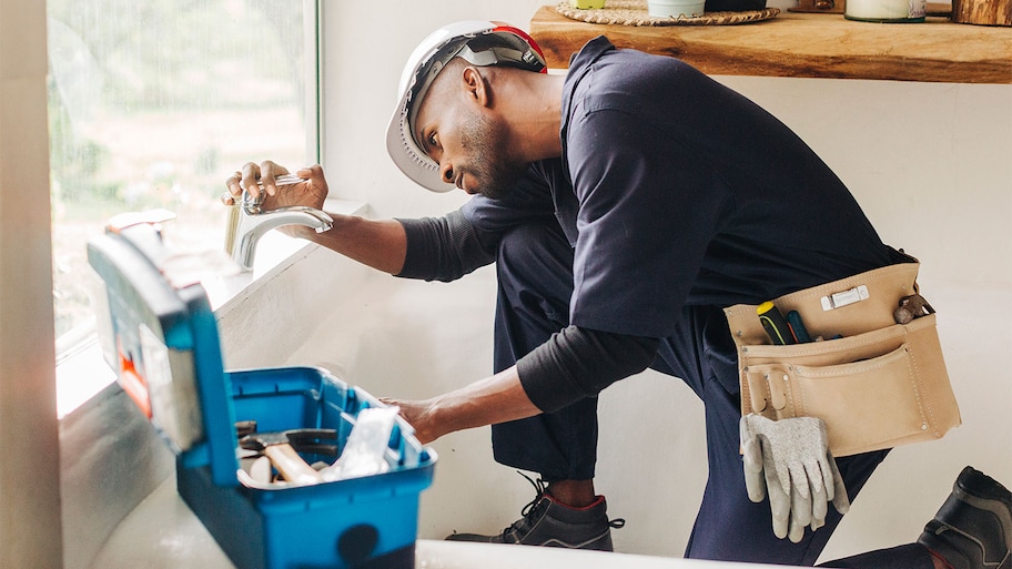 A plumber checks pipes