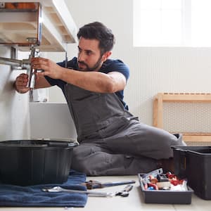 Man repairing under sink.