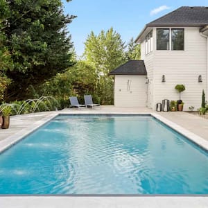 A pool in the backyard of a house