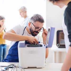 A professional repairing a small appliance 