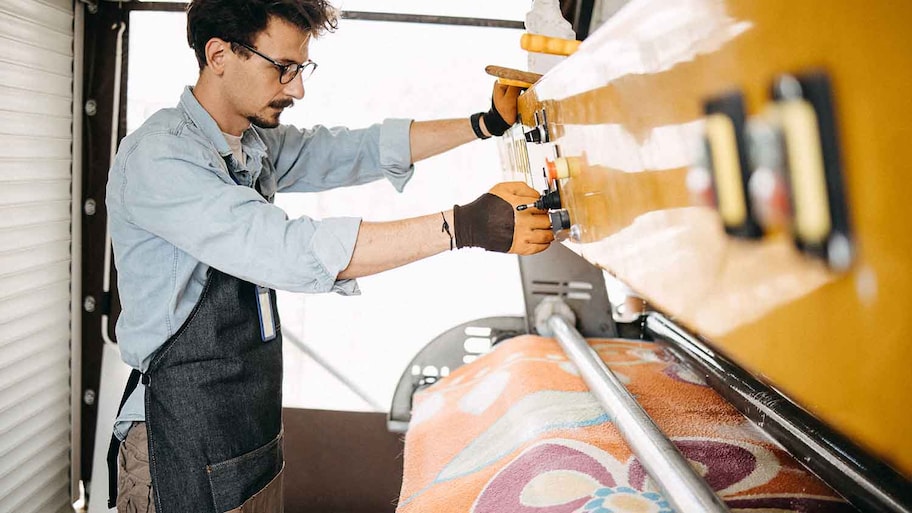 Technician using machine to clean a rug 