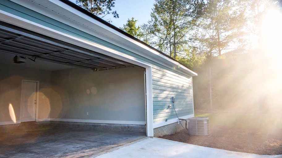 A residential garage with an open door 