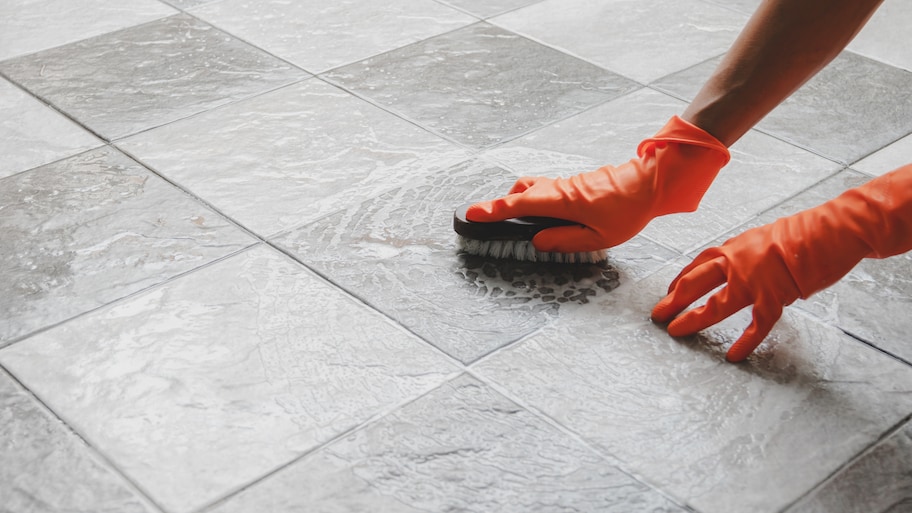 Cleaning tile with a scrubbing brush and soap