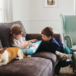 Siblings and pet sitting on the couch