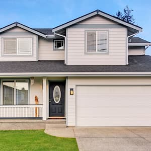 beige home with single driveway