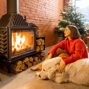  Woman and her dog sitting by a wood burning stove