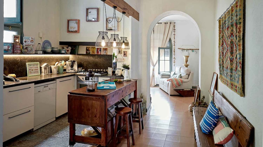 Small kitchen with wooden island and stools