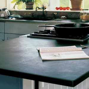 A soapstone countertop with a frypan on the stove