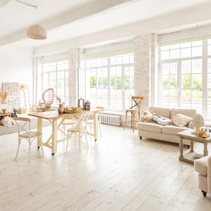 A spacious room resembling a loft with large windows