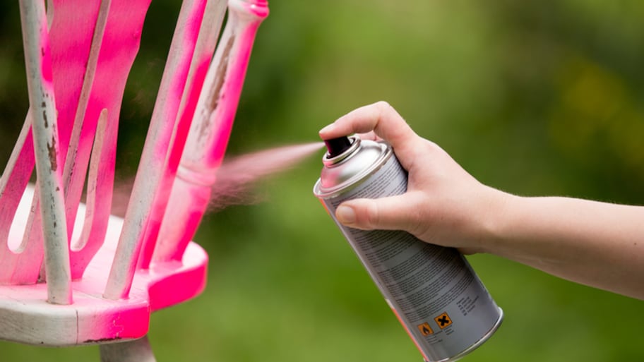 Spray painting an old chair pink