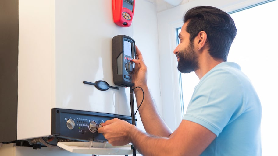 A technician installing a hot water heater