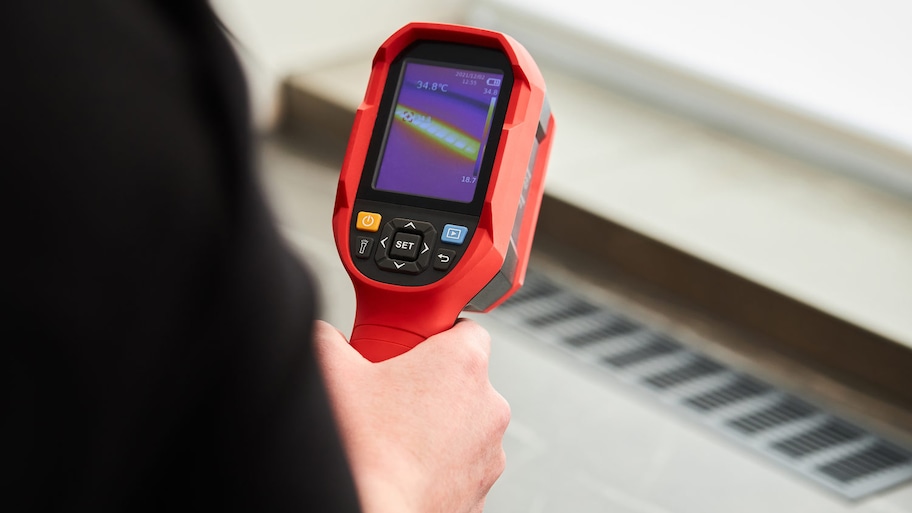 person holding a thermal imaging device