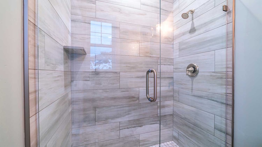 A closeup of a tiled shower