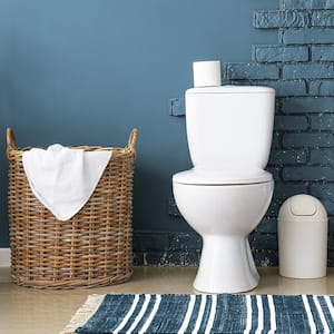 Toilet in bathroom with blue brick walls