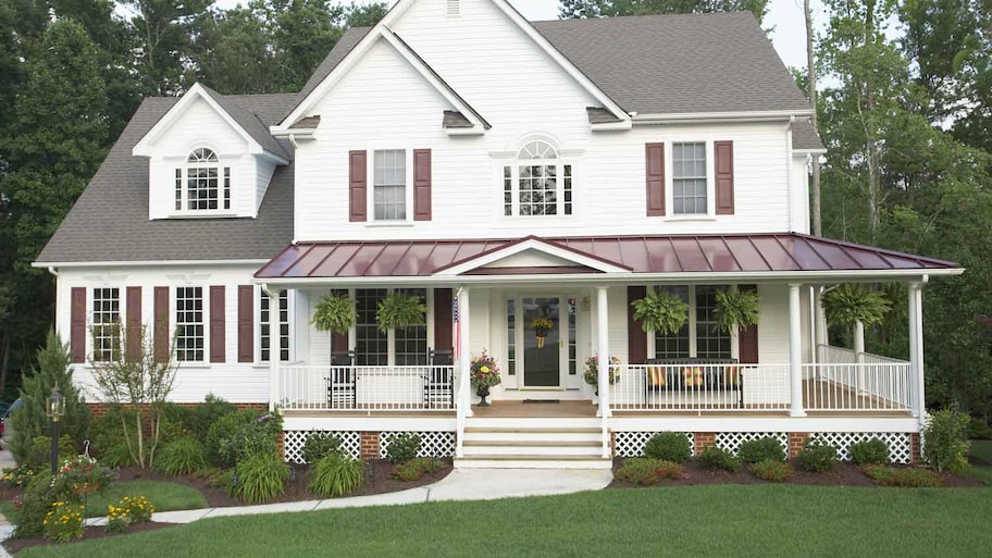 A traditional home with a wrap-around porch