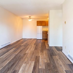 A vacant room with baseboard heaters