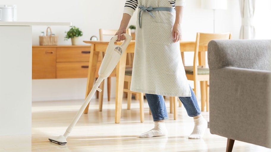 Cleaning dining room floor with vacuum