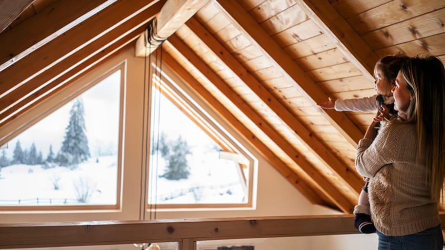 Mom and daughter looks out window of vaulted ceiling