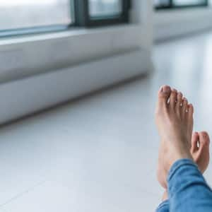 warm feet on a tile floor by a baseboard heater