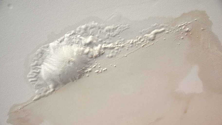 Brown spots and paint peeling off the ceiling