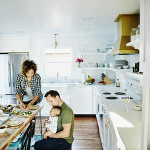 Happy diverse family in a white kitchen