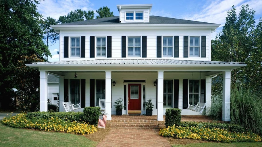 A white wooden house with a front porch