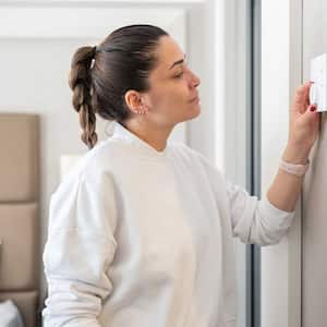 Woman adjusting temperature in the bedroom