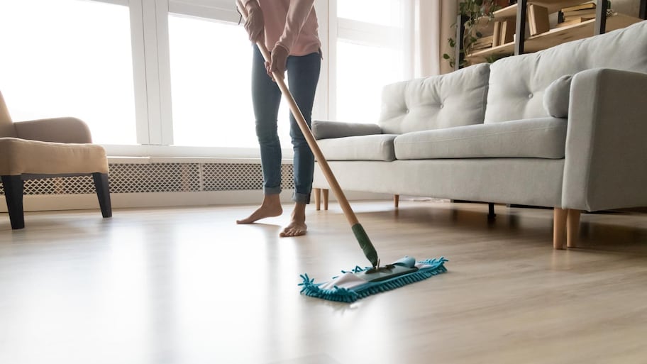 A woman cleaning floor with wet mop pad