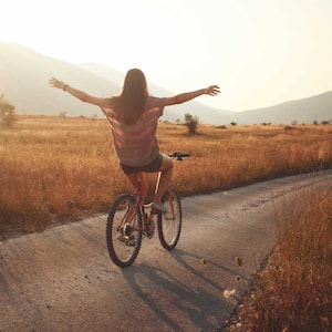 A woman cycling in the countryside