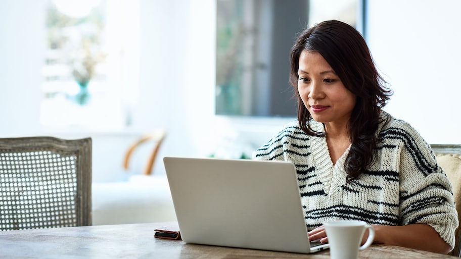 A woman doing online research on her laptop