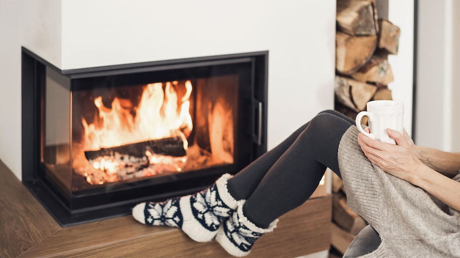 Woman in front of fireplace