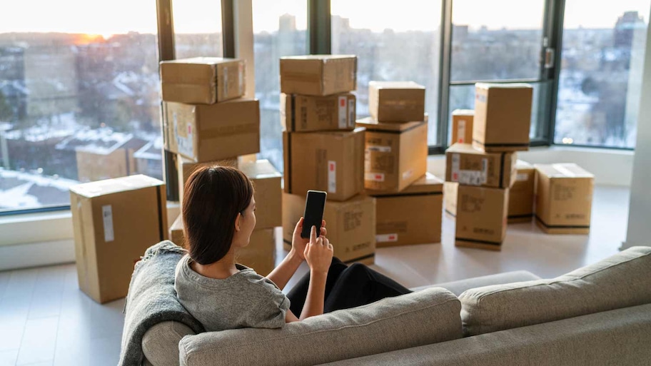 woman moving out of apartment with moving boxes