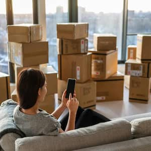 woman moving out of apartment with moving boxes