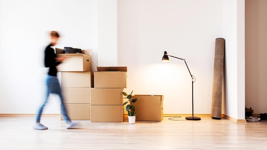 A woman in her new apartment with carboard boxes