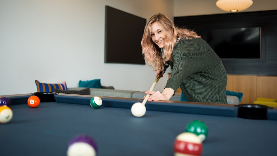 woman playing pool at home  