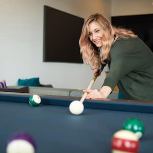 woman playing pool at home  