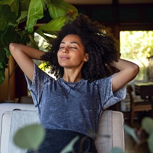 Woman breath deeply in her home