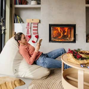 Woman sitting by the fireplace reading a book