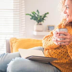 Woman on sofa in yellow sweater