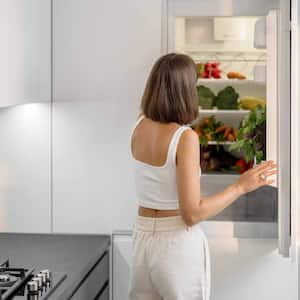 Woman standing near the fridge