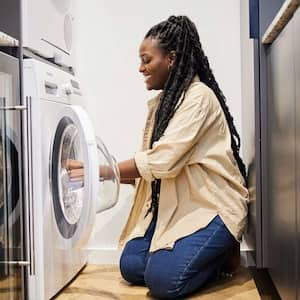 woman smiling washing clothes