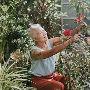 Woman trimming a plant in her garden