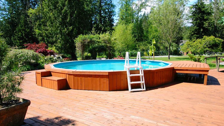 A wooden deck with an above ground pool