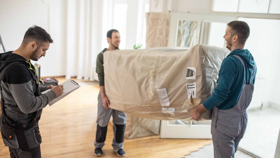 workers bringing in furniture in house