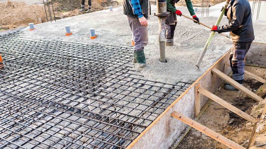 Workers pouring concrete foundation