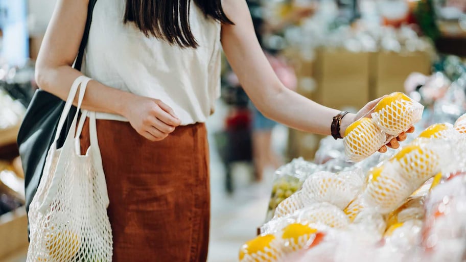 A young woman buying fresh fruit