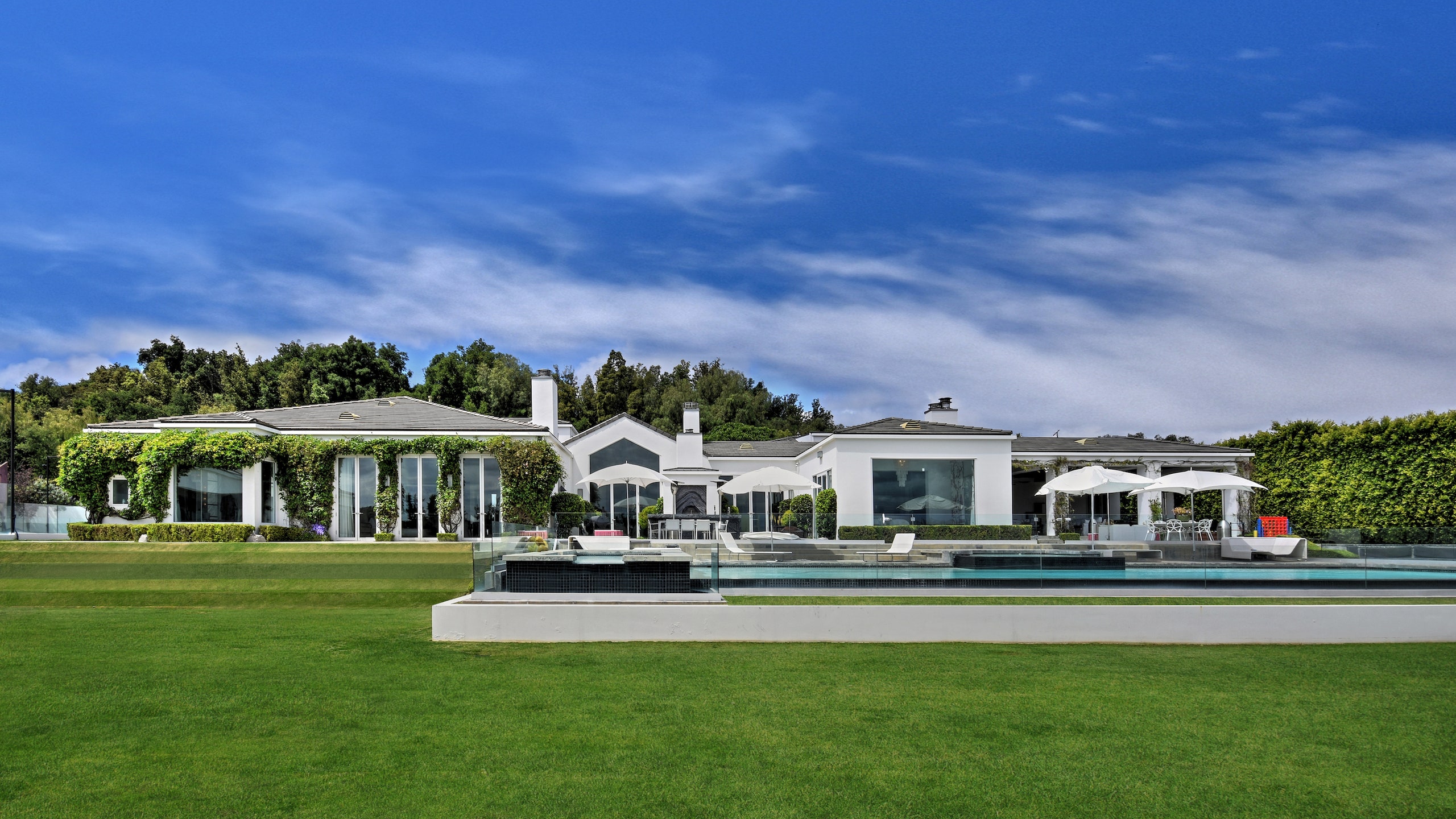 a white house with a yard and a pool