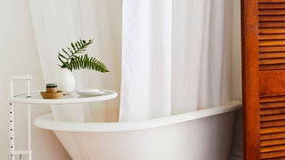 Image may contain Home Decor Interior Design Indoors Tub Bathtub Curtain and Wood