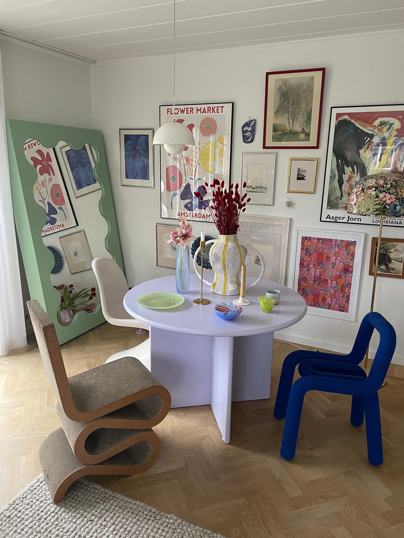 Gustaf Westman's curvy mirror and round table with the Frank Gehry wiggle side chair.