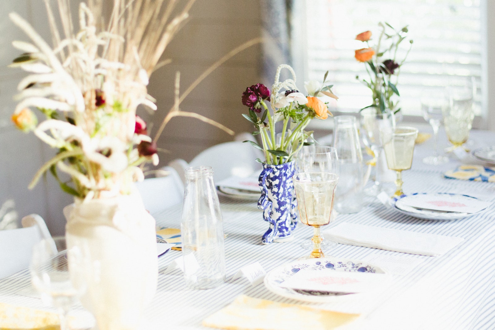 The wild beauty of the foraged florals and grasses take center stage in this colorblocked tablescape.